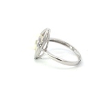Freshwater pearl ring sitting in a marquise frame