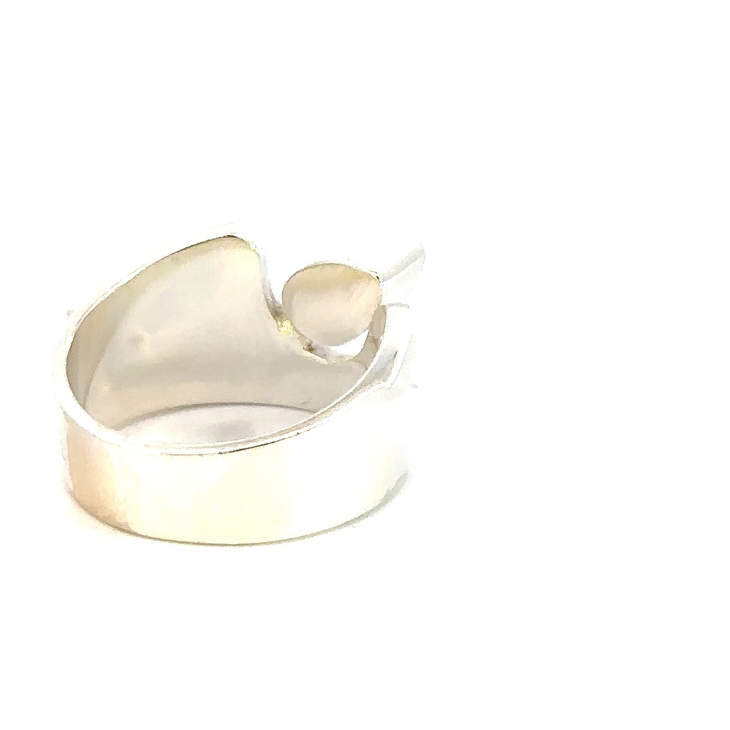 Wide sterling silver ring set with a pear shaped opal