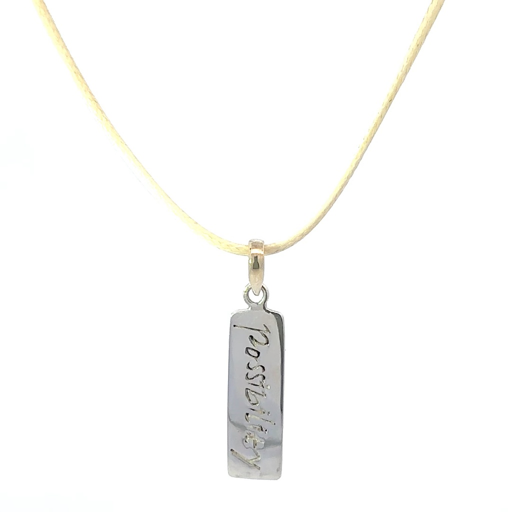 Pendant Tag With "Possibility" Engraved On It On Cream Cord